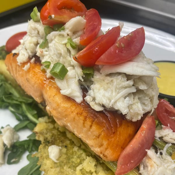 Brunch House 1850's salmon dish topped with crab meat, tomatoes, and green onions.