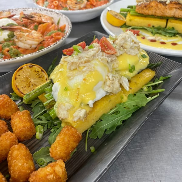 Brunch House 1850's crab benedict with asparagus, grilled lemon, tater tots, and other dishes.